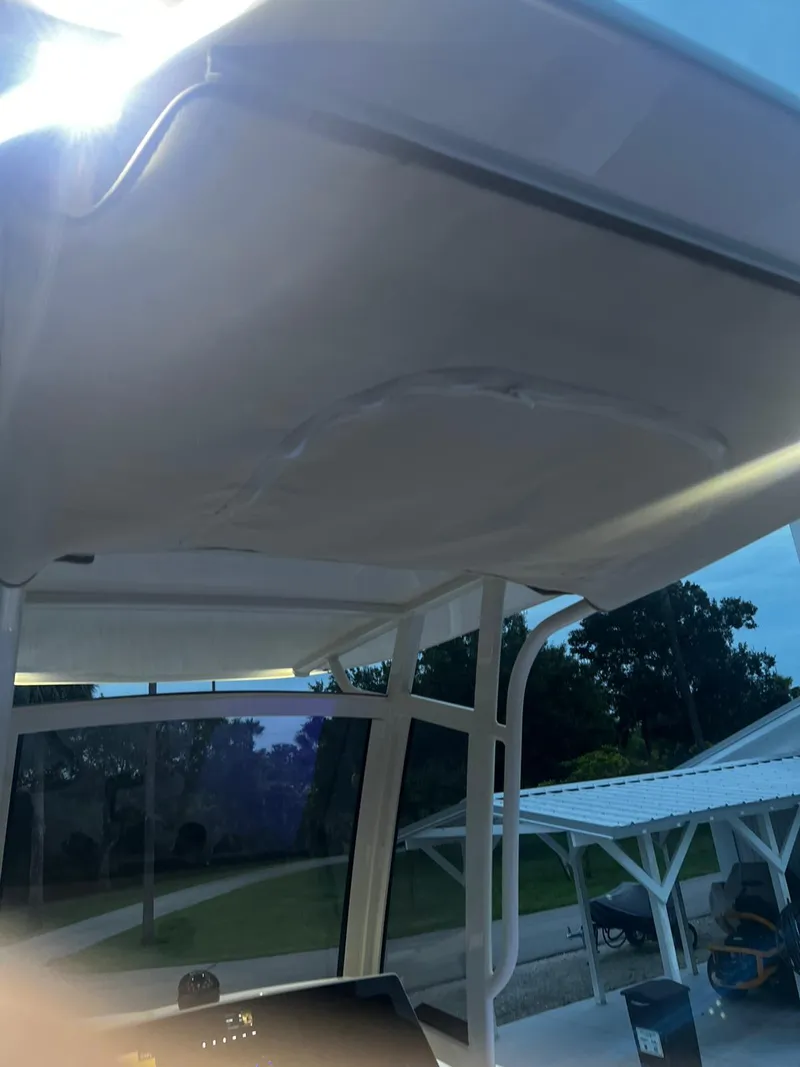 Slide: The Image of 2024 Scout 215 XSF boat canopy under bright sunlight. - 8