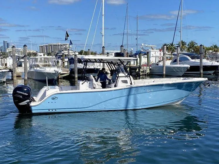 Slide: The Image of 2022 Sea Fox 328 Commander boat docked in a marina, clear blue sky. - 0