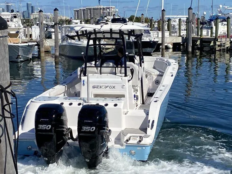Slide: The Image of 2022 Sea Fox 328 Commander boat with twin 350 engines docked in a marina. - 11