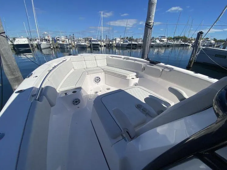 Slide: The Image of 2022 Sea Fox 328 Commander boat docked at marina under clear blue sky. - 13