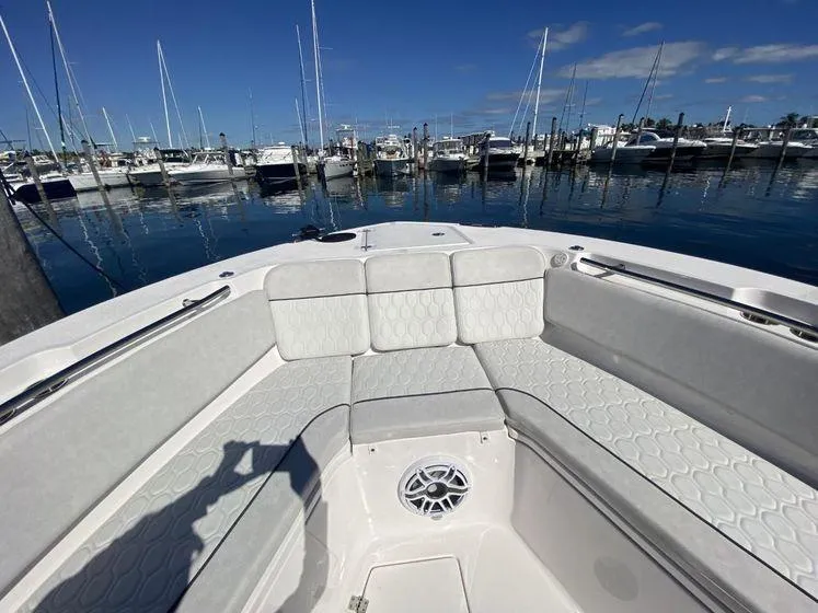 Slide: The Image of 2022 Sea Fox 328 Commander boat interior at marina, featuring spacious seating and clear blue sky. - 14