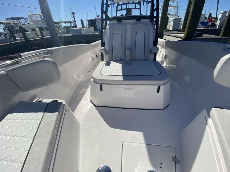 Slide: The Image of 2022 Sea Fox 328 Commander boat interior with seating and console, docked at marina. - 15