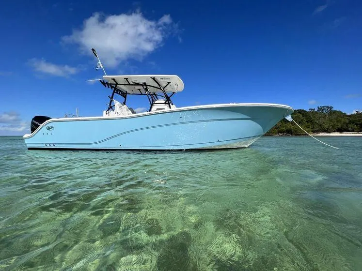 Slide: The Image of 2022 Sea Fox 328 Commander boat in clear water under blue sky. - 2