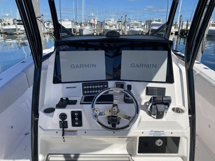 Slide: The Image of 2022 Sea Fox 328 Commander helm with dual Garmin displays at marina. - 22