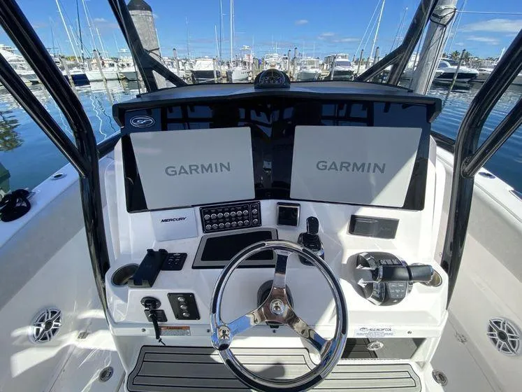 Slide: The Image of 2022 Sea Fox 328 Commander helm with dual Garmin displays at marina. - 25
