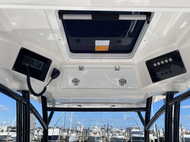 Slide: The Image of 2022 Sea Fox 328 Commander boat interior with control panels and overhead hatch. - 27