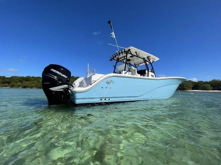 Slide: The Image of 2022 Sea Fox 328 Commander boat in clear water, featuring a Mercury engine. - 3