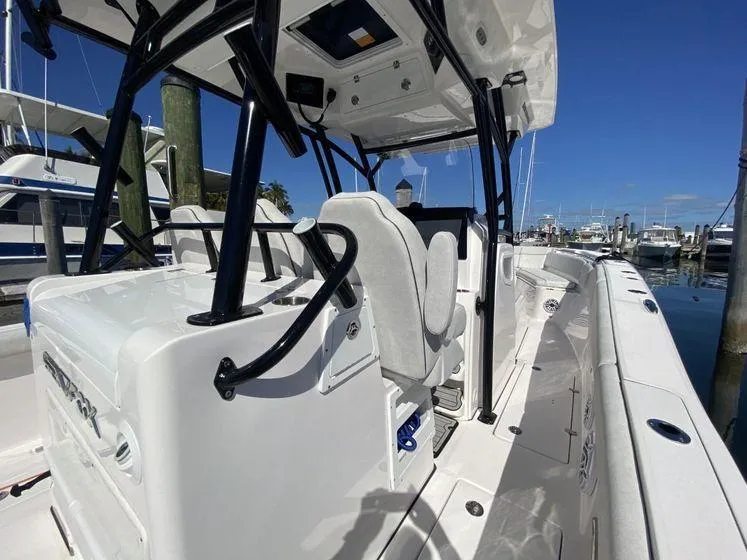 Slide: The Image of 2022 Sea Fox 328 Commander boat interior at marina, showcasing seating and helm. - 31