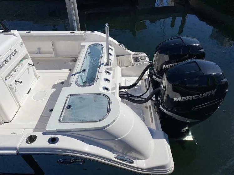 Slide: The Image of 2022 Sea Fox 328 Commander boat with dual Mercury engines, docked in water. - 34