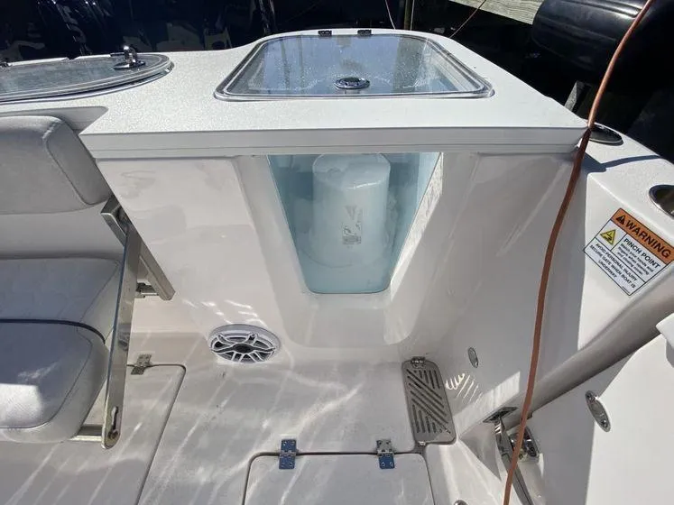 Slide: The Image of 2022 Sea Fox 328 Commander boat interior with seating, storage, and safety warning label. - 38