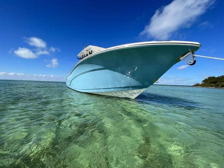 Slide: The Image of 2022 Sea Fox 328 Commander boat in clear turquoise water under a bright blue sky. - 5