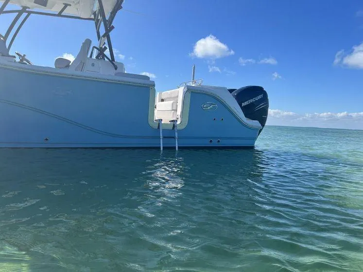 Slide: The Image of 2022 Sea Fox 328 Commander boat on calm ocean waters under a clear blue sky. - 7
