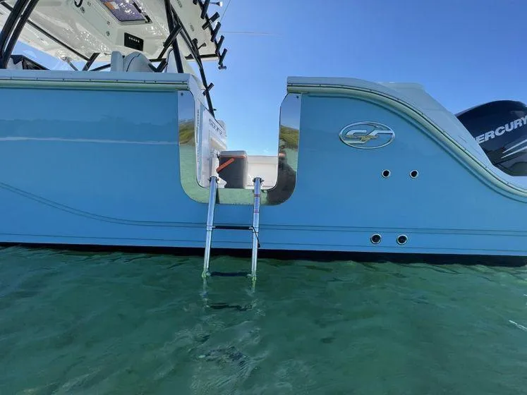 Slide: The Image of 2022 Sea Fox 328 Commander boat with ladder, floating on clear water. - 8