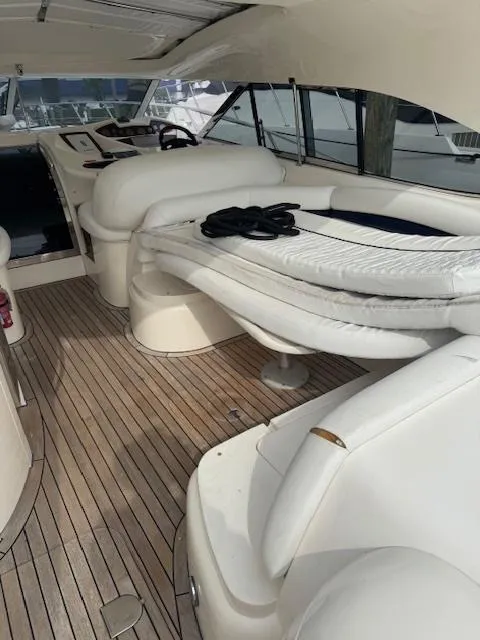 Slide: The Image of 2000 Sunseeker Predator 60 yacht interior with luxurious seating and wooden flooring. - 4