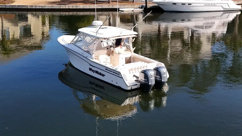 Slide: The Image of 2014 Grady-White Freedom 307 boat docked on calm water. - 12