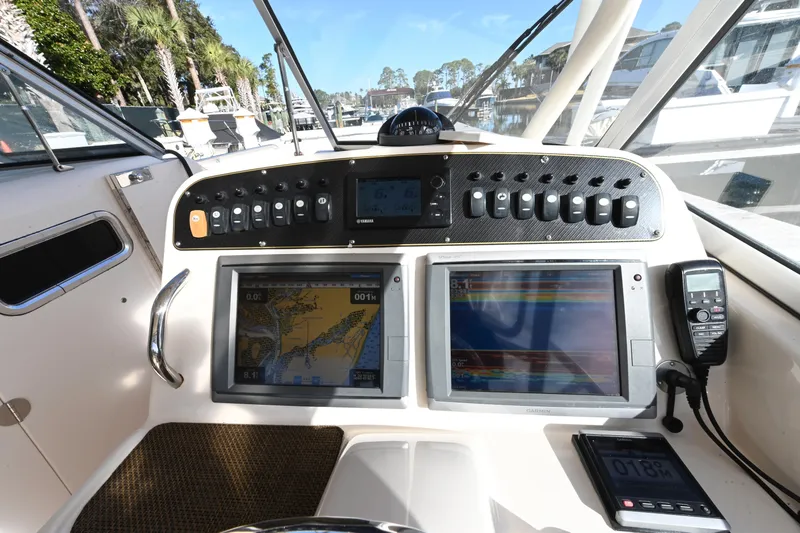 Slide: The Image of 2014 Grady-White Freedom 307 boat dashboard with navigation screens and controls. - 14