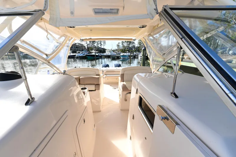 Slide: The Image of 2014 Grady-White Freedom 307 boat interior with seating, docked at marina. - 19