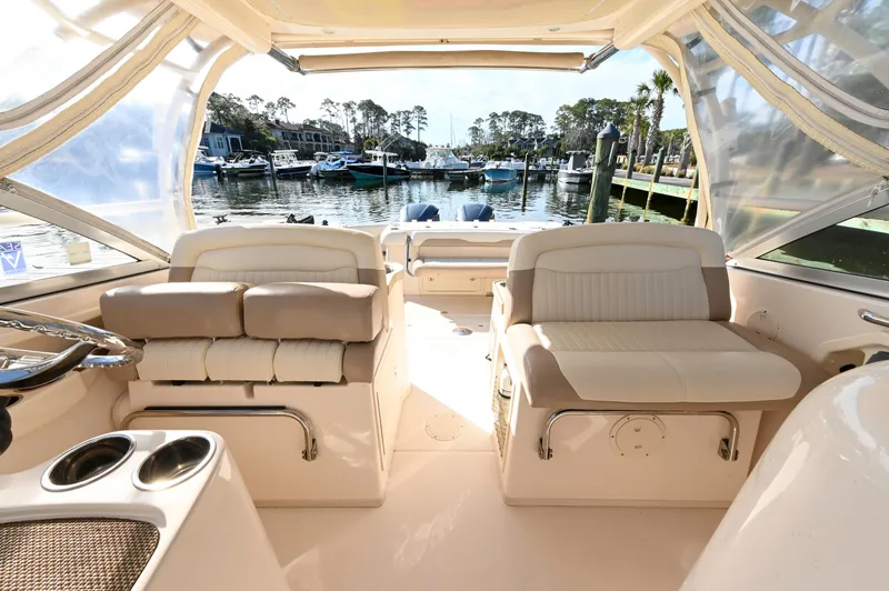 Slide: The Image of 2014 Grady-White Freedom 307 boat interior with seating, docked at marina. - 21