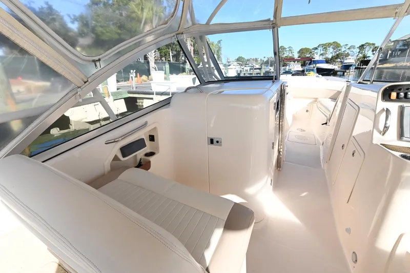 Slide: The Image of 2014 Grady-White Freedom 307 boat interior with seating and helm station. - 22