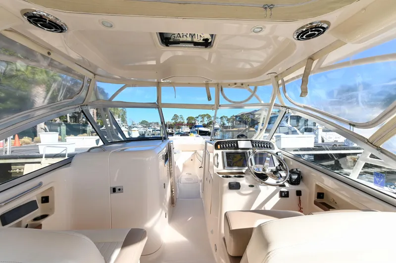Slide: The Image of Interior view of 2014 Grady-White Freedom 307 boat, featuring helm and seating area. - 23
