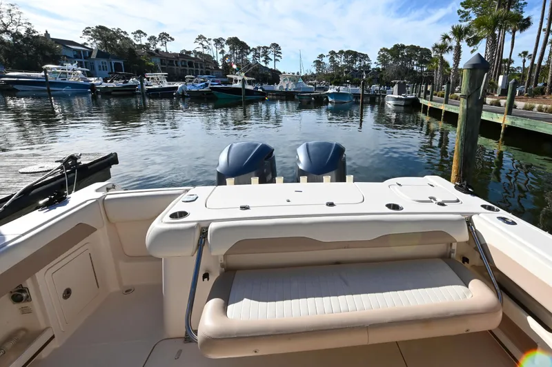 Slide: The Image of 2014 Grady-White Freedom 307 boat docked in a marina with twin engines. - 24