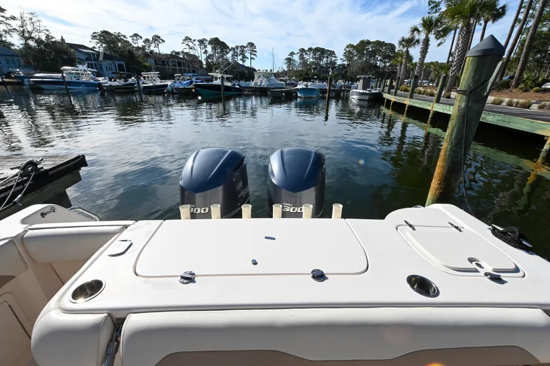 Slide: The Image of 2014 Grady-White Freedom 307 boat docked in a marina with twin engines. - 25