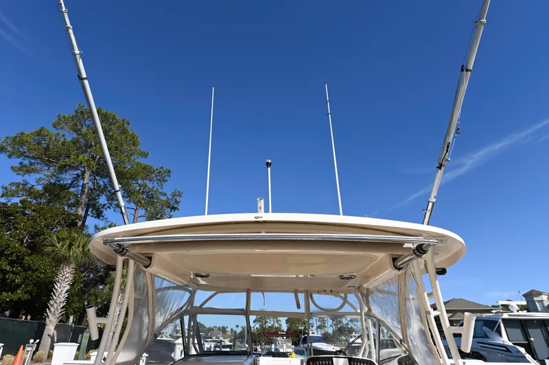 Slide: The Image of 2014 Grady-White Freedom 307 boat with fishing rods, clear sky background. - 32