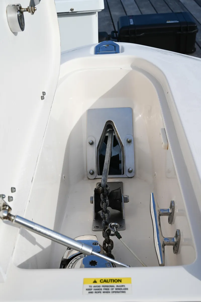 Slide: The Image of Anchor compartment of 2014 Grady-White Freedom 307 boat with chain and winch. - 33