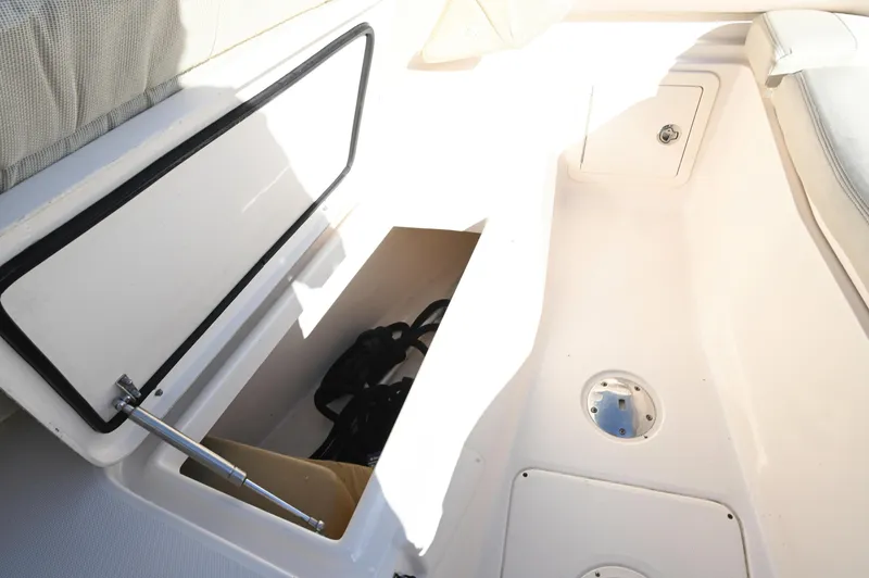 Slide: The Image of 2014 Grady-White Freedom 307 boat storage compartment, open with visible interior space. - 37