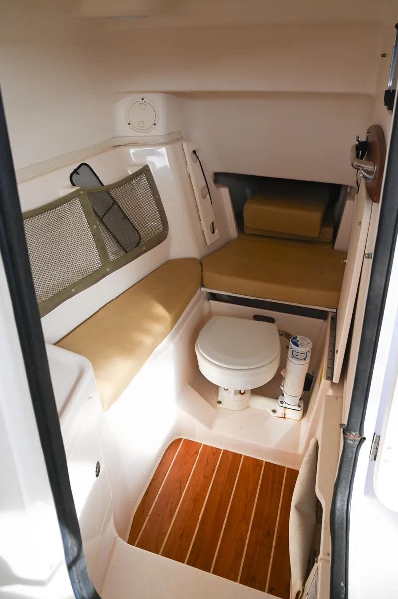 Slide: The Image of 2014 Grady-White Freedom 307 boat interior with seating and toilet. - 38