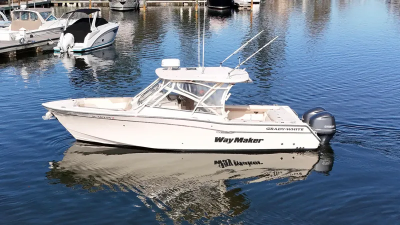 Slide: The Image of 2014 Grady-White Freedom 307 boat on calm water, reflecting marina background. - 7
