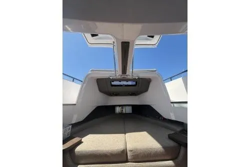 Slide: The Image of 2024 Axopar 37 XC Cross Cabin interior with open sunroof and seating area. - 12