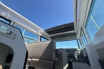 Slide: The Image of 2024 Axopar 37 XC Cross Cabin interior with open sunroof and modern seating. - 13