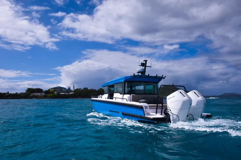 Slide: The Image of 2024 Axopar 37 Cross Cabin boat cruising on blue ocean under cloudy sky. - 3