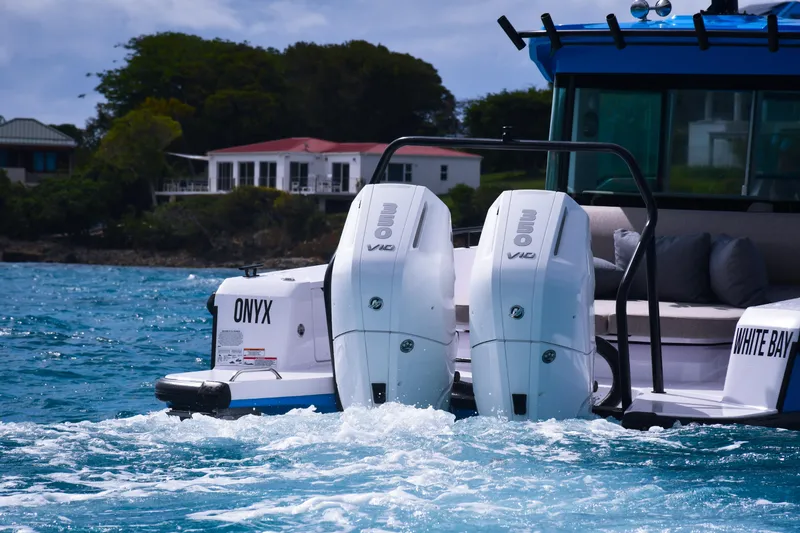 Slide: The Image of 2024 Axopar 37 Cross Cabin with twin outboard engines cruising on blue water. - 6