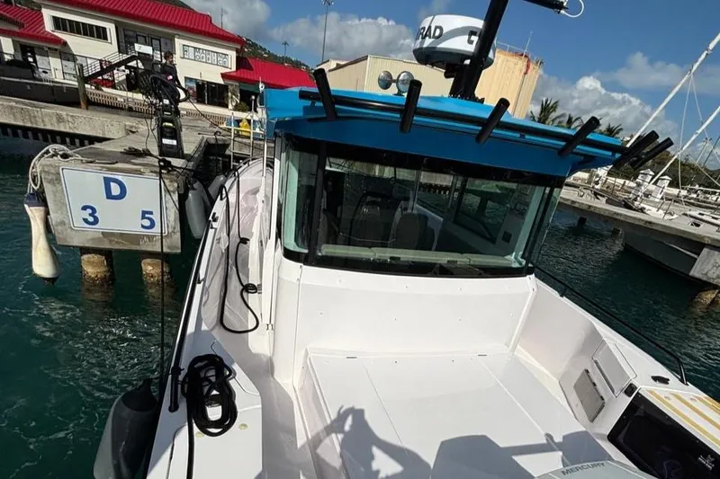 Slide: The Image of 2024 Axopar 37 Cross Cabin docked at marina, showcasing sleek design and modern features. - 9