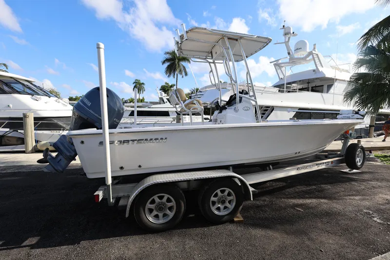 Slide: The Image of 2022 Sportsman Masters 207 Bay Boat on trailer, docked with yachts in background. - 26