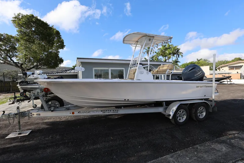 Slide: The Image of 2022 Sportsman Masters 207 Bay Boat on trailer, parked outdoors under blue sky. - 31