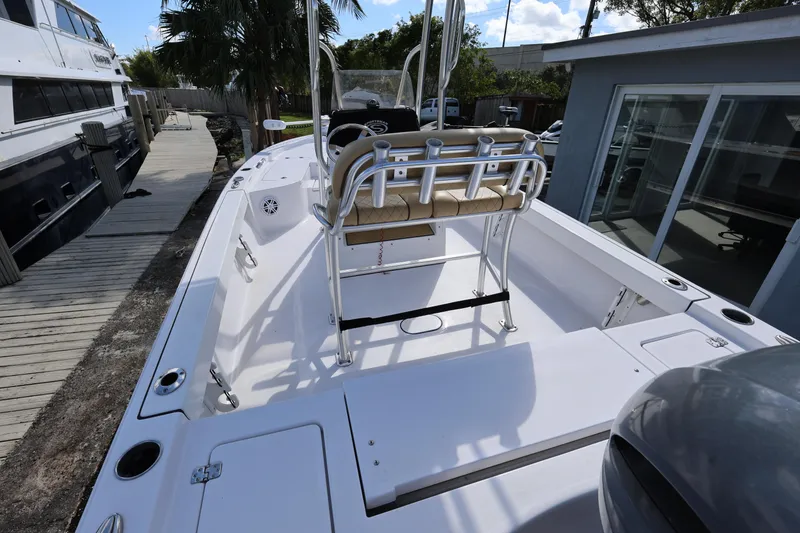 Slide: The Image of 2022 Sportsman Masters 207 Bay Boat docked, showcasing spacious deck and seating. - 34