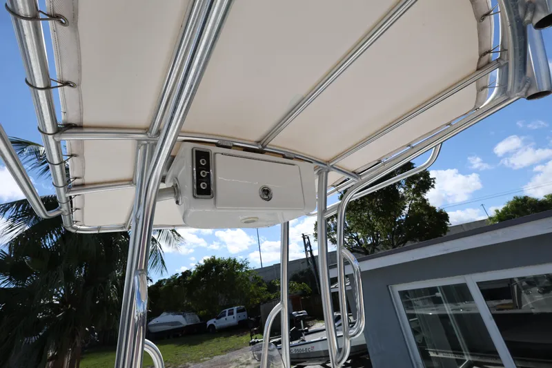 Slide: The Image of T-top of 2022 Sportsman Masters 207 Bay Boat with electronics box, outdoors. - 36