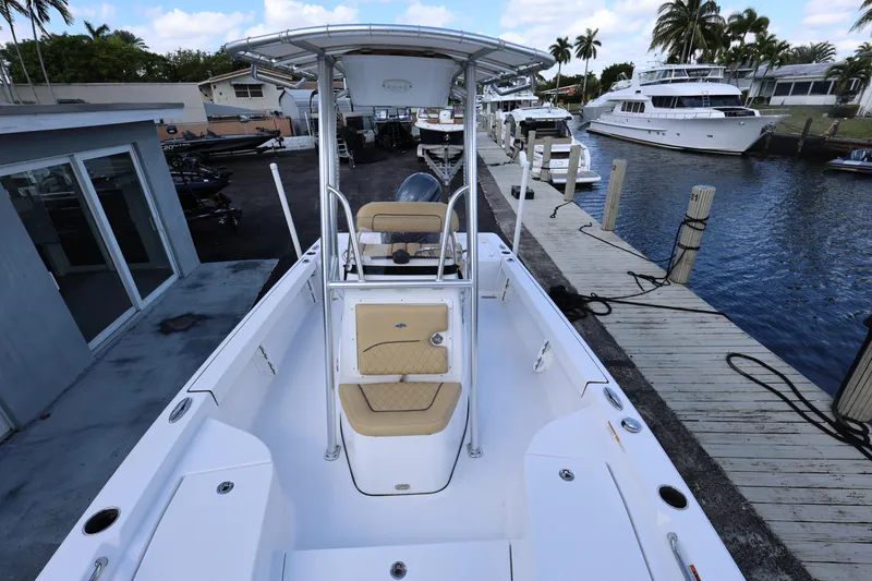 Slide: The Image of 2022 Sportsman Masters 207 Bay Boat docked, featuring spacious deck and seating. - 42