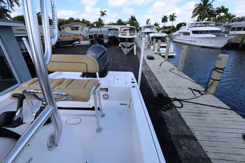 Slide: The Image of 2022 Sportsman Masters 207 Bay Boat docked at marina with yachts and palm trees. - 44