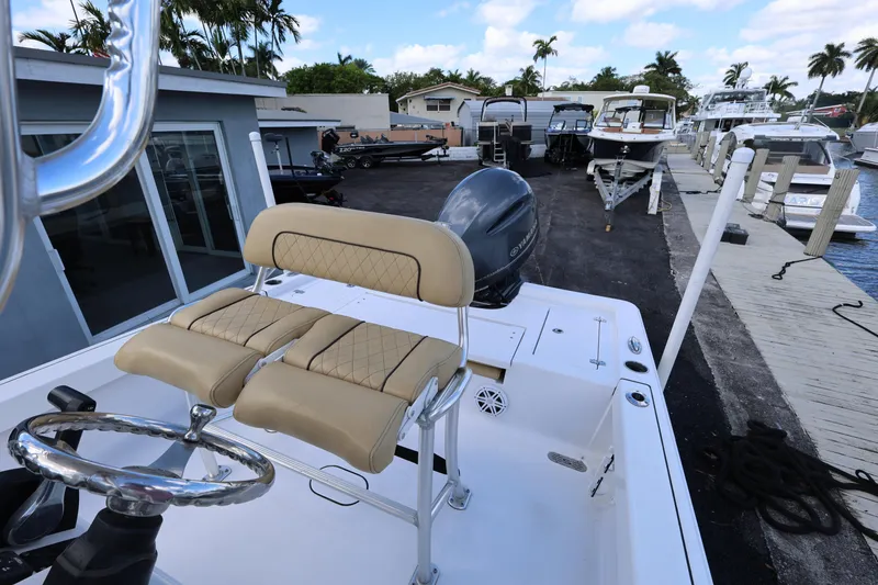 Slide: The Image of 2022 Sportsman Masters 207 Bay Boat docked, featuring dual seats and steering wheel. - 45