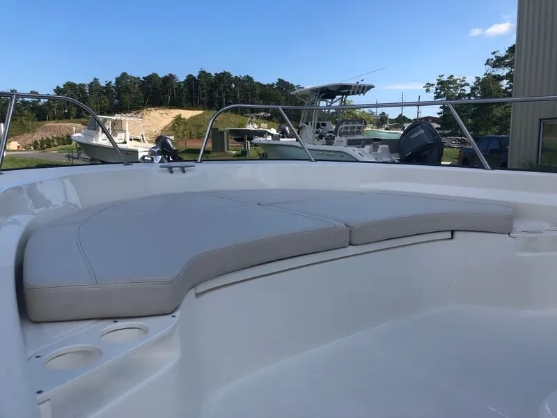 Slide: The Image of 2024 Boston Whaler 190 Montauk boat interior with cushioned seating and cup holders. - 3