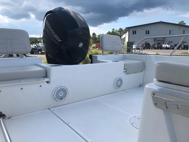 Slide: The Image of 2024 Boston Whaler 190 Montauk boat interior with Mercury engine, outdoor setting. - 5