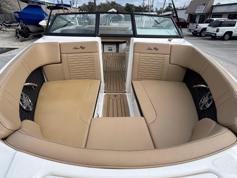 Slide: The Image of 2021 Sea Ray SPX 230 boat interior with tan leather seating and wood flooring. - 11