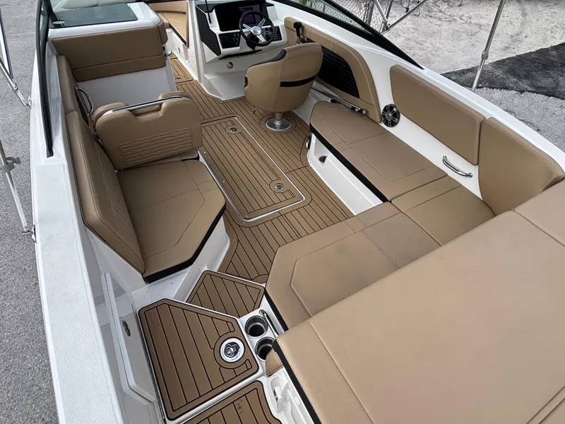Slide: The Image of 2021 Sea Ray SPX 230 boat interior with tan seating and sleek design. - 15