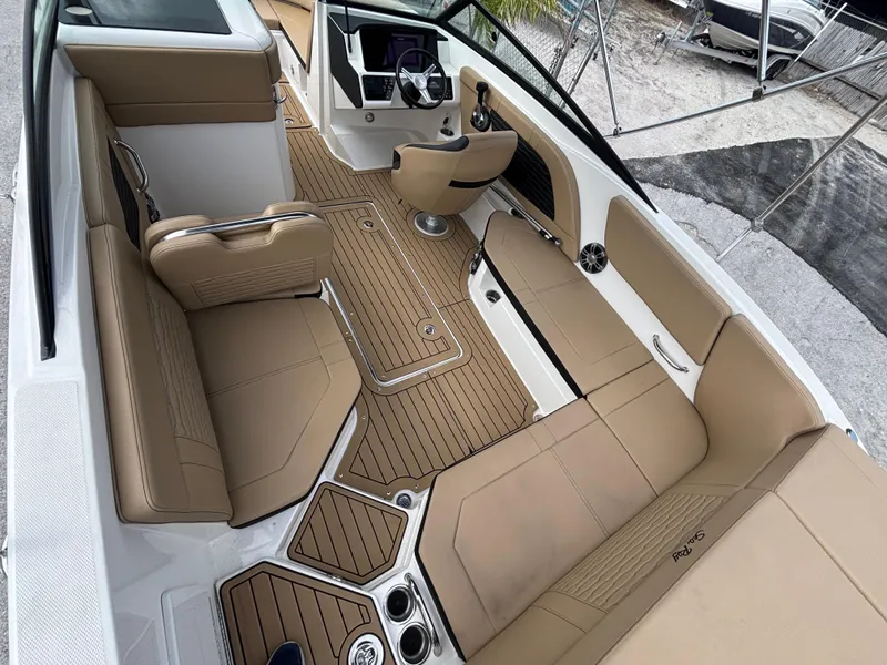 Slide: The Image of 2021 Sea Ray SPX 230 boat interior with tan seating and sleek design. - 16