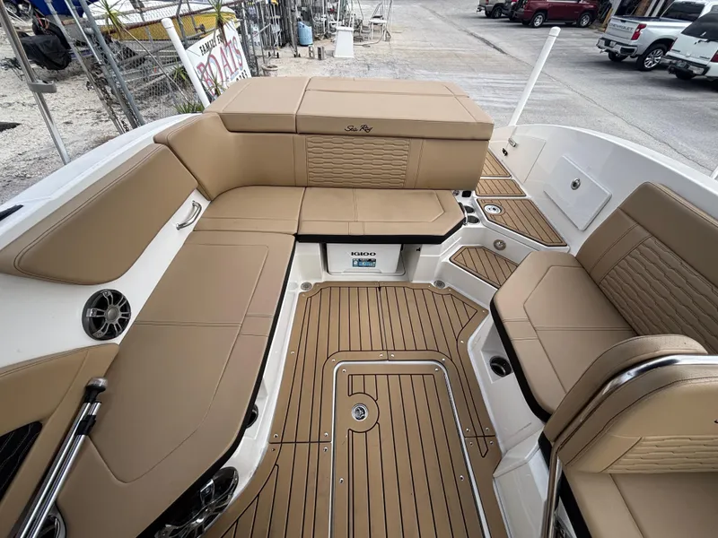 Slide: The Image of 2021 Sea Ray SPX 230 boat interior with tan seating and teak flooring. - 21