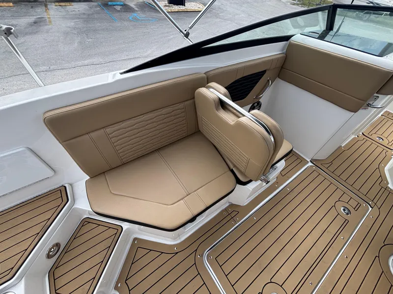 Slide: The Image of 2021 Sea Ray SPX 230 boat interior with tan seating and teak-style flooring. - 23